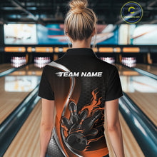 Load image into Gallery viewer, Female model back view at bowling lane wearing black and orange quarter zip shirt featuring flaming bowling ball striking pins artwork