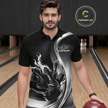Load image into Gallery viewer, Male model seen from the front in a bowling lane wearing a black and gray polo shirt featuring a flame bowling ball and pins design in a dynamic sports scene.