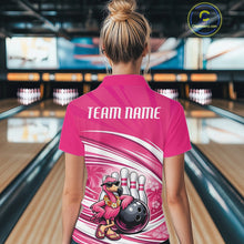 Load image into Gallery viewer, Back view of a female model in a bowling center wearing a pink polo shirt showcasing a tropical flamingo and bowling ball artwork.