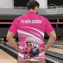 Load image into Gallery viewer, Front view of a male model in a bowling alley wearing a pink quarter-zip shirt featuring tropical flamingo and bowling ball artwork.