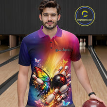 Load image into Gallery viewer, Male model wearing a bowling polo shirt at a bowling lane with a rainbow butterfly, bowling ball, and scattered pin artwork.