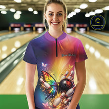Load image into Gallery viewer, Female model at a bowling lane wearing a quarter-zip bowling shirt with a rainbow butterfly, bowling ball, and scattered pin artwork.