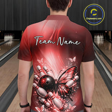 Load image into Gallery viewer, Back view of a male model in a bowling alley wearing a red polo shirt featuring a butterfly beside a bowling ball and bowling pins.