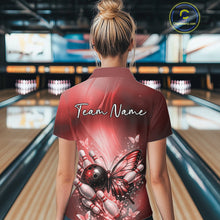Load image into Gallery viewer, Back view of a female model in a bowling center wearing a red polo shirt featuring a butterfly beside a bowling ball and bowling pins.