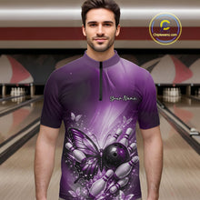 Load image into Gallery viewer, Male model wearing a purple bowling quarter-zip shirt at a bowling lane with butterfly artwork, bowling ball graphics, and scattered pins.
