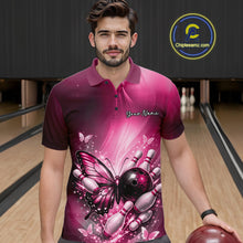 Load image into Gallery viewer, Male model at a bowling lane wearing a pink bowling polo shirt with butterfly artwork, a bowling ball, and scattered pin accents.