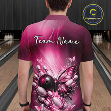 Load image into Gallery viewer, Back view of a male model in a bowling center wearing a pink polo shirt featuring a butterfly beside a bowling ball and pins.