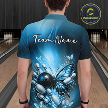 Load image into Gallery viewer, Back view of a male model in a bowling alley wearing a blue polo shirt featuring a butterfly beside a bowling ball and bowling pins.