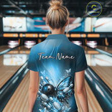 Load image into Gallery viewer, Back view of a female model in a bowling center wearing a blue polo shirt featuring a butterfly beside a bowling ball and bowling pins.