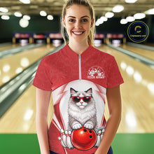 Load image into Gallery viewer, Female model shown from the front in a bowling venue wearing a quarter-zip shirt with a ragdoll cat in sunglasses and bowling ball artwork.