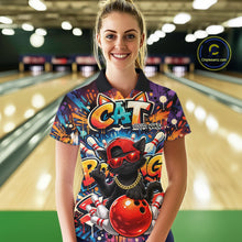 Load image into Gallery viewer, Female model wearing a colorful bowling polo shirt at a bowling lane with graffiti-style black cat artwork, sunglasses, cap, and bowling ball graphics.