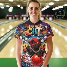 Load image into Gallery viewer, Female model wearing a colorful bowling quarter-zip shirt at a bowling lane with graffiti-style black cat artwork, sunglasses, cap, and bowling ball graphic.