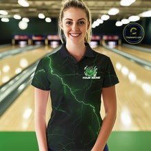 Load image into Gallery viewer, Female model at the bowling lane wearing a black and green bowling polo with fantasy dragon claw artwork and fiery bowling details.