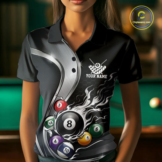 Front view of a female model wearing a black and silver billiard polo with metallic ribbon accents, a dark honeycomb pattern, and a flaming 8-ball surrounded by pool balls