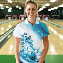 Load image into Gallery viewer, Female model wearing a white and blue bowling polo with butterfly artwork and bowling graphics, front view inside a bowling center