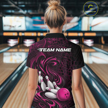Load image into Gallery viewer, Back view of a female model wearing a black and pink bowling polo shirt in a bowling alley featuring a tribal flame bowling ball and pins graphic