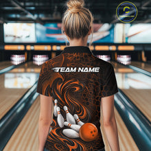 Load image into Gallery viewer, Back view of a female model wearing a black and orange bowling quarter-zip shirt in a bowling alley featuring a tribal flame bowling ball and pins graphic