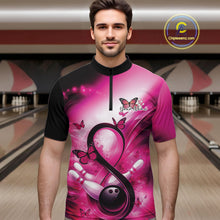 Load image into Gallery viewer, Male model in a bowling alley wearing a quarter-zip shirt with a pink ribbon, bowling ball, and butterfly illustration.