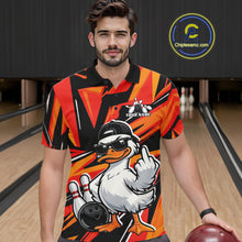 Load image into Gallery viewer, Male model wearing a black and orange bowling polo in a bowling center with duck-themed bowling artwork.