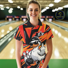 Load image into Gallery viewer, Female model wearing a black and orange bowling polo featuring a duck in sunglasses and cap with bowling lane-inspired artwork.