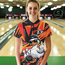 Load image into Gallery viewer, Female model in a bowling center wearing a black and orange quarter-zip with duck-themed bowling artwork and geometric accents.
