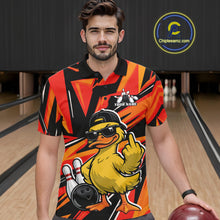 Load image into Gallery viewer, Male model at a bowling alley wearing a black and orange polo featuring a duck in sunglasses and cap with geometric details.
