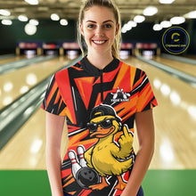 Load image into Gallery viewer, Front view of a female model at a bowling alley wearing a black and orange quarter-zip featuring a duck in sunglasses and cap.