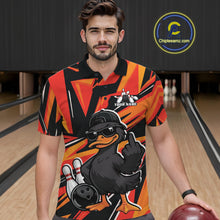 Load image into Gallery viewer, Male model wearing a black and orange bowling polo in a bowling lane with duck-themed graphics and geometric background elements.