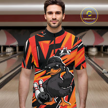 Load image into Gallery viewer, Male model wearing a black and orange bowling quarter-zip in a bowling lane with duck-themed bowling artwork and geometric background.