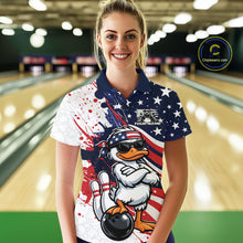 Load image into Gallery viewer, Female model at the bowling lane wearing a bowling polo displaying a patriotic duck illustration with sunglasses and bowling-themed artwork.
