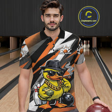 Load image into Gallery viewer, Male model at the bowling lane wearing a black and orange bowling polo with duck-themed bowling artwork and pin graphics.