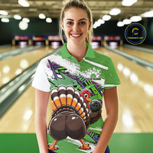 Load image into Gallery viewer, Front view of a female model wearing a green custom bowling polo shirt with a funny graffiti turkey holding a bowling ball, paint splatter accents, and a personalized name in a bowling alley.