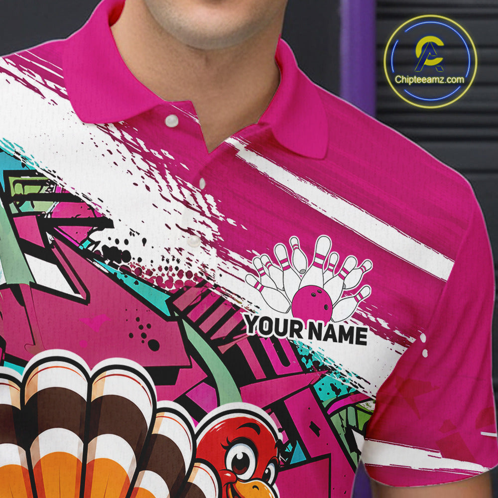 Close up front view of the left chest area on a pink custom bowling polo shirt, featuring a graffiti inspired urban street style design with paint splatter accents and a personalized name.