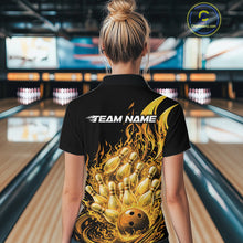 Load image into Gallery viewer, Back view in bowling lane showing female model wearing black and yellow bowling quarter zip featuring flaming bowling ball striking pins with fiery action graphics.