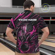 Load image into Gallery viewer, Front view of a male model in a bowling alley wearing a black and pink quarter-zip shirt featuring a flaming bowling ball hitting the pins.