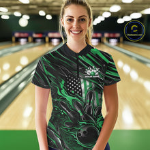 Load image into Gallery viewer, Female model in a bowling alley wearing black and green quarter zip shirt, front view featuring patriotic flaming bowling ball hitting pins dynamic artwork