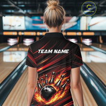 Load image into Gallery viewer, Back view of a female model in a bowling alley wearing a black and red-orange polo shirt featuring a bowling ball knocking down pins.