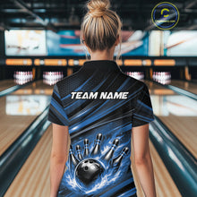 Load image into Gallery viewer, Back view of a female model in a bowling center wearing a black and blue polo shirt featuring a flaming bowling ball hitting the pins.