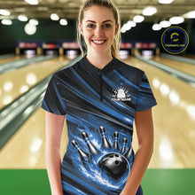 Load image into Gallery viewer, Female model in a bowling lane wearing black and blue quarter zip shirt, front view featuring fiery bowling ball hitting pins with bold abstract design