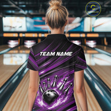 Load image into Gallery viewer, Back view of a female model in a bowling venue wearing a black and purple polo shirt featuring a bowling strike graphic with flame effects.
