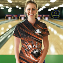 Load image into Gallery viewer, Female model wearing a black and orange bowling polo shirt at a bowling lane with bowling strike artwork and bold stripe details.