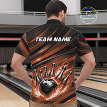 Load image into Gallery viewer, Front view of a male model in a bowling center wearing a black and orange quarter-zip shirt featuring a flaming bowling ball and pin motif.