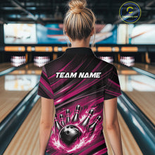 Load image into Gallery viewer, Back view of a female model in a bowling center wearing a black and pink polo shirt featuring a flaming bowling ball and pin design.