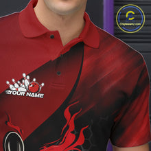 Load image into Gallery viewer, Back view of a male model in a bowling alley wearing a black and red polo shirt featuring a flaming bowling ball and pin motif.