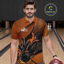Load image into Gallery viewer, Male model at a bowling lane wearing a black and orange bowling polo shirt with fiery bowling action graphics and hexagonal accents.