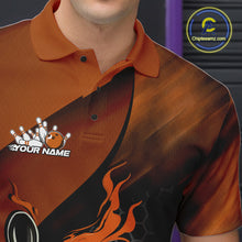 Load image into Gallery viewer, Close-up of the left chest area on a black and orange bowling polo shirt featuring a flaming bowling ball and pin design with hexagon details.