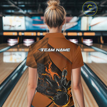 Load image into Gallery viewer, Back view of a female model in a bowling center wearing a black and orange polo shirt featuring a flaming bowling strike scene.
