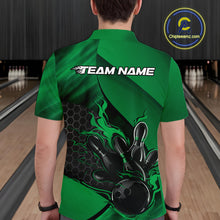 Load image into Gallery viewer, Back view of a male model in a bowling venue wearing a black and green polo shirt featuring a flaming bowling ball and pin motif.