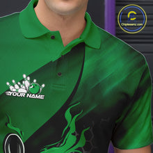 Load image into Gallery viewer, Close-up left chest view of a black and green bowling polo shirt featuring a flaming bowling ball striking pins over a hexagon pattern.