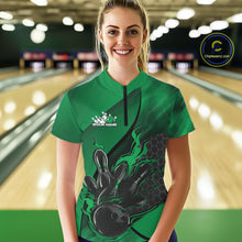 Load image into Gallery viewer, Female model in a bowling lane wearing black and green quarter zip shirt, front view featuring flaming bowling ball striking pins with hexagon design